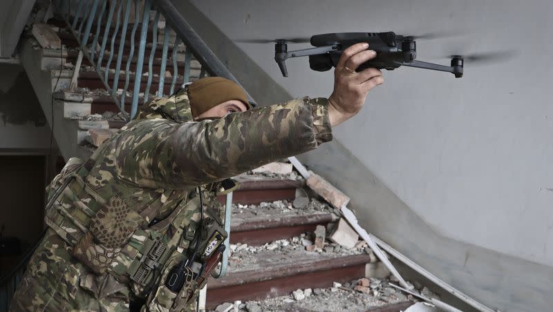 A Ukrainian soldier launches a drone in the area of the heaviest battles with Russian invaders in Bakhmut, Donetsk region, Ukraine, Wednesday, March 15, 2023.