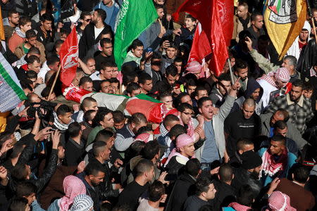 Mourners carry the body of Palestinian protester Malek Shahin, who medics said was shot dead by Israeli troops while they were carrying out an arrest raid on Tuesday, during his funeral in the West Bank Deheishe Refugee Camp, south of Bethlehem December 8, 2015. REUTERS/Abdelrahman Younis