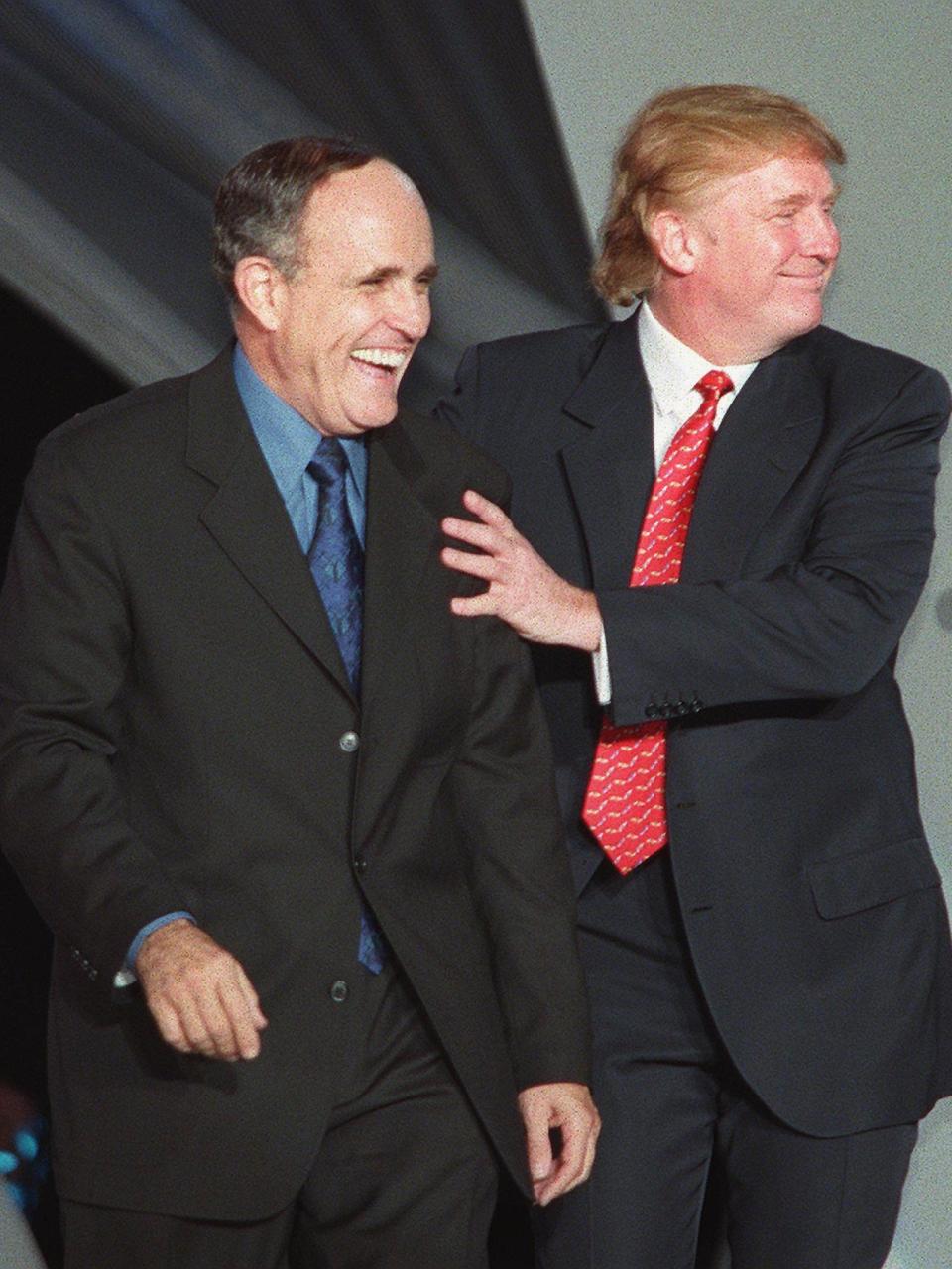 <p>The terrible twosome: Giuliani and Trump walk down the runway during the NYC2000 fashion show</p>AFP/Getty