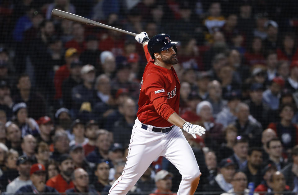Boston Red Sox's J.D. Martinez follows through on his two-run home run against the Colorado Rockies during the third inning of a baseball game Wednesday, May 15, 2019, at Fenway Park in Boston. (AP Photo/Winslow Townson)