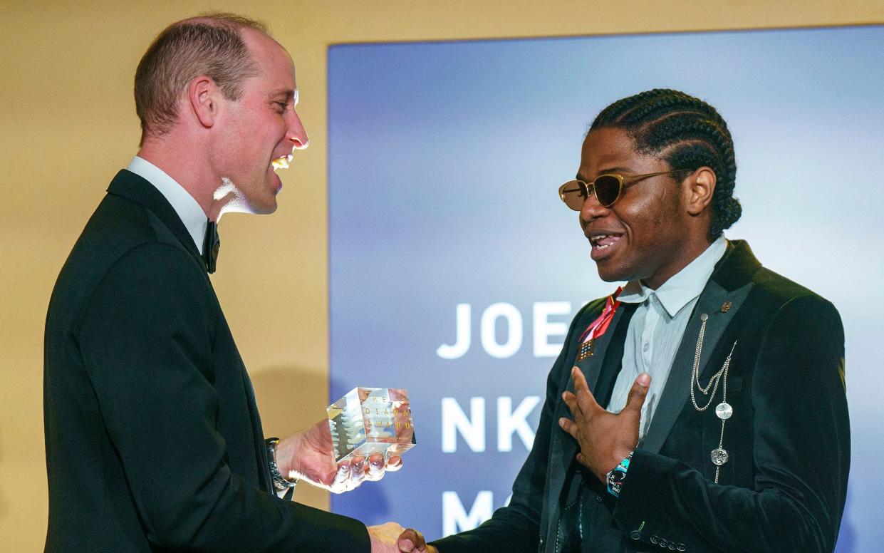 Britain's Prince William, Prince of Wales presents an award to Joel Mordi