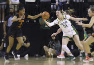 Baylor forward Caitlin Bickle, right, and Oklahoma State guard Micah Dennis, left, reach for the ball during the first half of an NCAA college basketball game Wednesday, Jan. 19, 2022, in Waco, Texas. (Rod Aydelotte/Waco Tribune Herald via AP)
