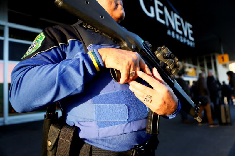 FILE PHOTO: County of Geneva police officer stands guard outside Cointrin airport in Geneva