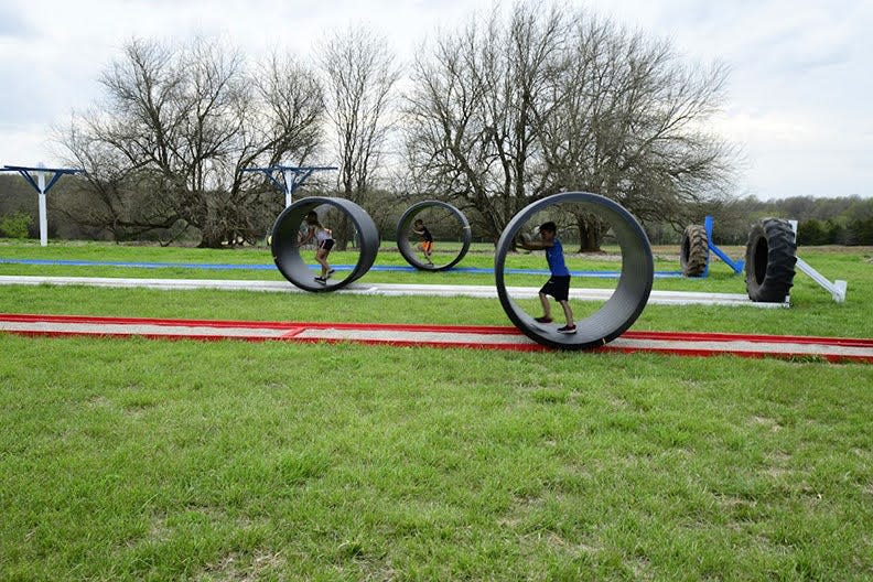 Kids race inside plastic culverts