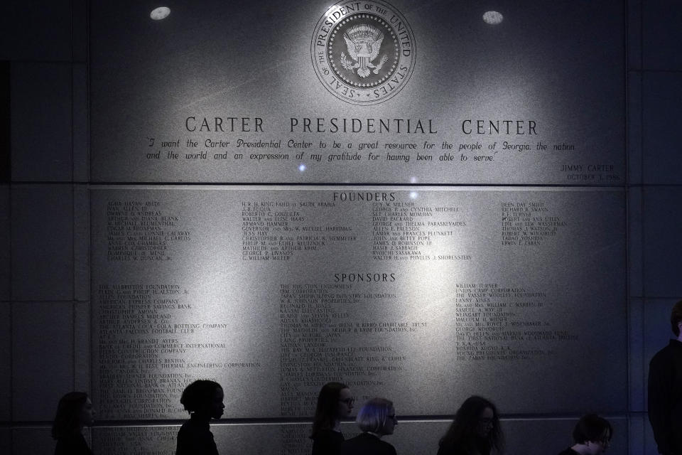 Choir members arrive to the Jimmy Carter Presidential Library and Museum where former first lady Rosalynn Carter lies in repose, in Atlanta, Monday, Nov. 27, 2023. Tributes started Monday morning as Rosalynn Carter's casket traveled by motorcade through the Carters' native Sumter County. (AP Photo/Brynn Anderson)