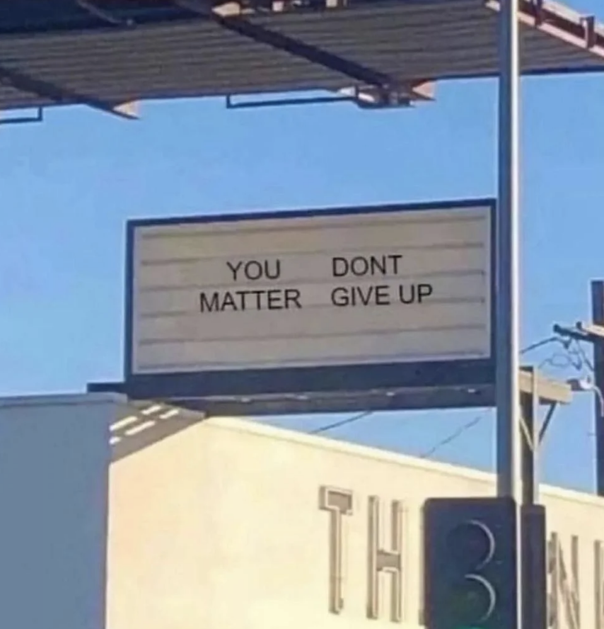 Billboard with text "YOU DON'T MATTER GIVE UP" possibly missing punctuation