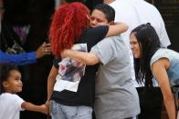 <p>People hug as they arrive for the funeral of Peter Gonzalez-Cruz and Gilberto Ramon Silva Menendez, both victims of the shooting at Pulse night club in Orlando on June 17, 2016. (Reuters/Carlo Allegri) </p>