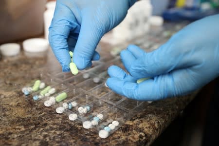 A pharmacist counts prescription drugs at the at the CentreTown Pharmacy in Ottawa