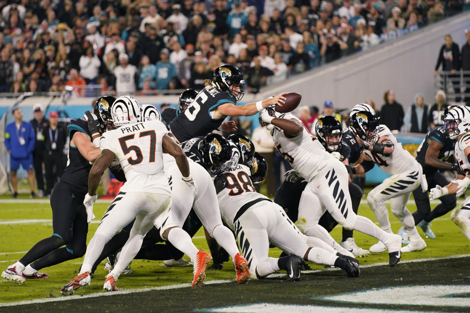 Jacksonville Jaguars quarterback Trevor Lawrence (16) jumps for a touchdown during the second half of an NFL football game against the Cincinnati Bengals, Monday, Dec. 4, 2023, in Jacksonville, Fla. (AP Photo/John Raoux)