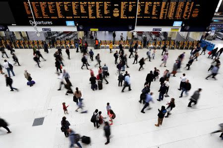 Passengers walk on the concourse at Waterloo station after one of the main railway lines into the station was disrupted by a signalling fault in central London, Britain July 24, 2017. REUTERS/Peter Nicholls