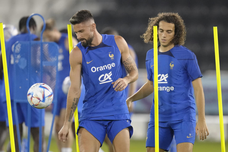 France's Olivier Giroud, left, and Matteo Guendouzi practise during a training session at the Jassim Bin Hamad stadium in Doha, Qatar, Saturday, Nov. 19, 2022. France will play their first match in the World Cup against Australia on Nov. 22. (AP Photo/Christophe Ena)