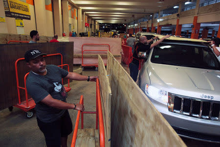 People buy materials at a hardware store after Puerto Rico Governor Ricardo Rossello declared a state of emergency in preparation for Hurricane Irma, in Bayamon, Puerto Rico September 4, 2017. REUTERS/Alvin Baez