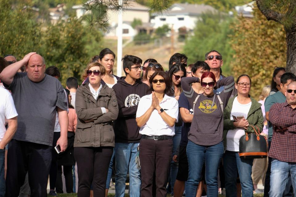 Parents wait to reunite with their children after a shooting (AP)