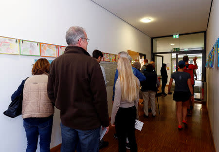 People wait to cast their vote for the Bavarian state election in Neubiberg, Germany, October 14, 2018. REUTERS/Michaela Rehle