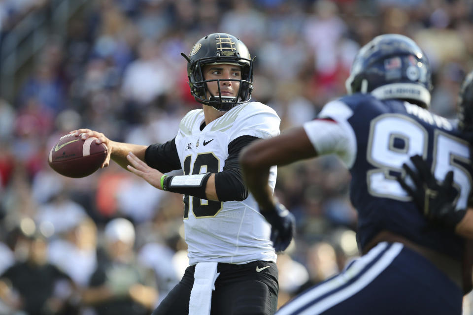 FILE - Purdue quarterback Jack Plummer (13) looks for a receiver during the first half of the team's NCAA football game against Connecticut on Sept. 11, 2021, in East Hartford, Conn. Plummer will be reunited this season at Louisville with offensive coordinator Brian Brohm, who was at Purdue. (AP Photo/Stew Milne)