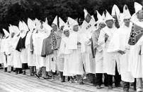 <p>About 75 Klansmen and women in robes protest the civil rights bill as they parade through the streets of St. Augustine, Fla., July 4, 1964. (Photo: Bill Hudson/AP) </p>