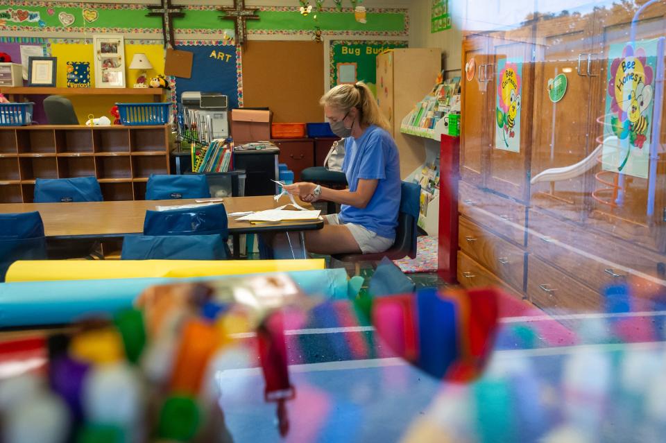 Liz Guidry working alone in her classroom preparing for when students return to school at Our Lady of Fatima Catholic School in New Orleans, Tuesday, July 28, 2020.