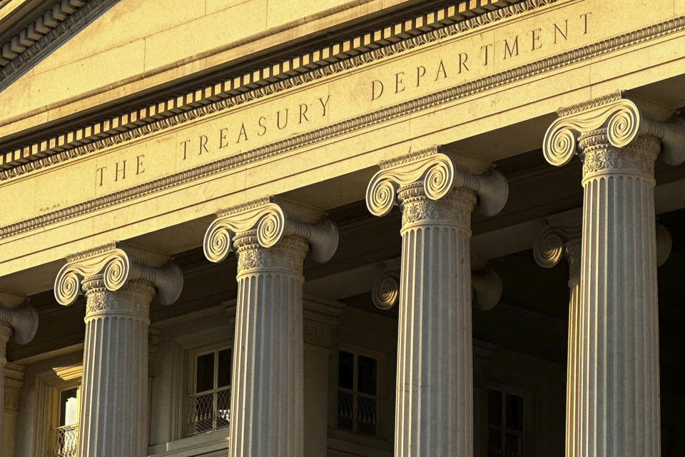 FILE - The Treasury Department is seen near sunset in Washington, Jan. 18, 2023. The Treasury Department says it has sanctioned two individuals and a Greece-based commercial spyware company headed by a former Israeli military officer that developed and distributed technology used to target U.S. government officials, journalists, and policy experts. (AP Photo/Jon Elswick, File)