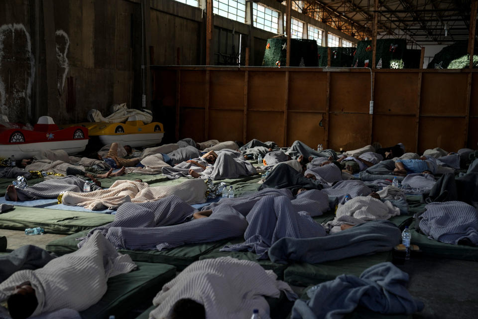 Survivors of a shipwreck sleep at a warehouse at the port in Kalamata, Greece on June 14, 2023.<span class="copyright">Thanassis Stavrakis—AP</span>