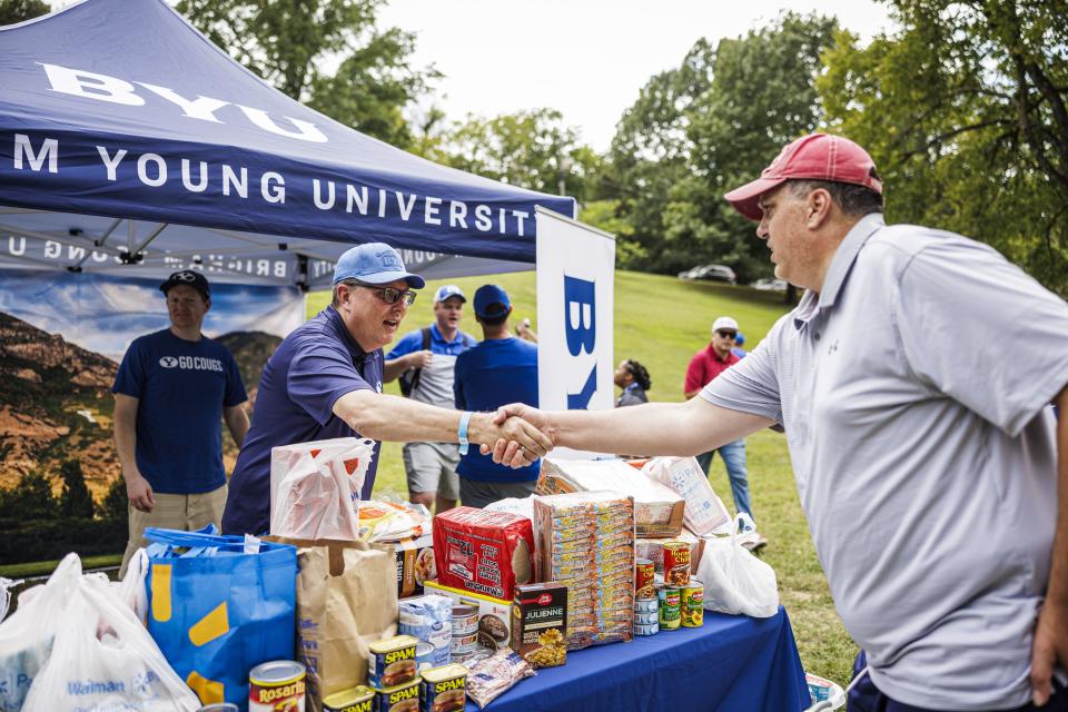 BYU fans bring food donations during the BYU tailgate to benefit the St. James Missionary Baptist Church in Fayetteville, Arkansas, on Saturday, Sept. 16, 2023. | Nate Edwards, BYU