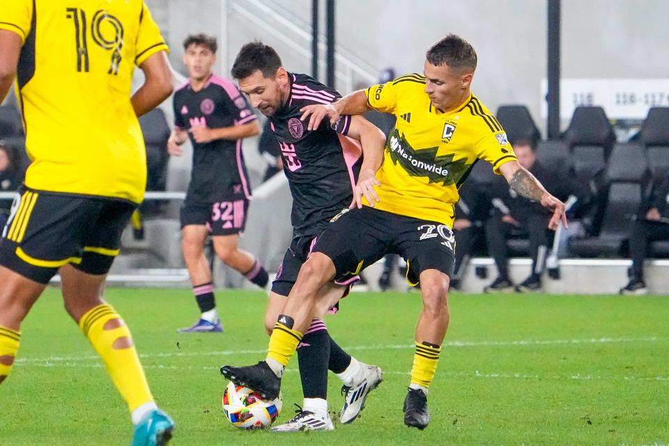 Oct 2, 2024; Columbus, OH, USA; Columbus Crew midfielder Alexandru Matan (20) fights for the ball against Inter Miami CF forward Lionel Messi (10) in the second half at Lower.com Field.