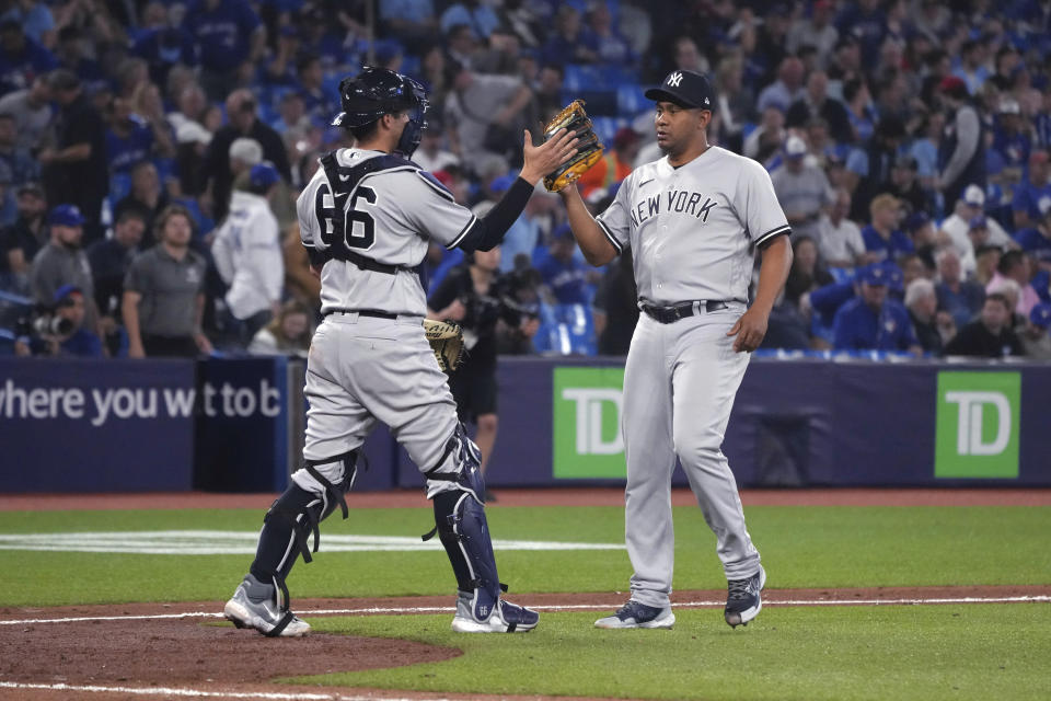 New York Yankees catcher Kyle Higashioka celebrates with pitcher Wandy Peralta after the Yankees defeated the Toronto Blue Jays in a baseball game Tuesday, May 16, 2023, in Toronto. (Chris Young/The Canadian Press via AP)