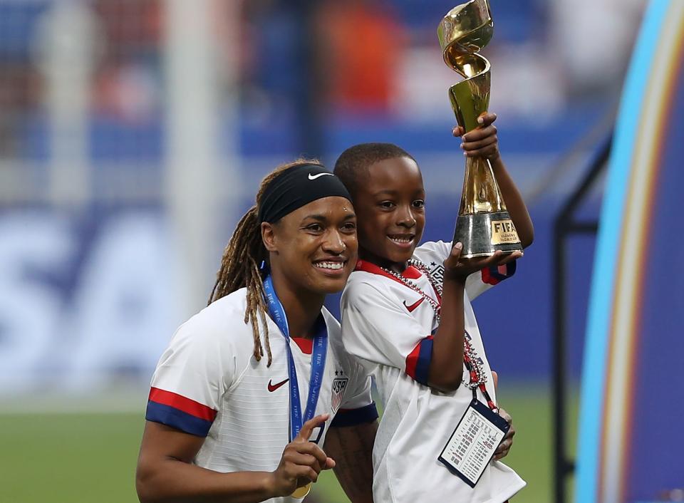 Jessica McDonald celebrates with her son following the USWNT's victory in the final of the 2019 FIFA Women's World Cup in France.
