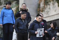 People line up at a Vancouver, British Columbia courthouse prior to the bail hearing for Meng Wanzhou, Huawei's chief financial officer on Monday, December 10, 2018. Meng Wanzhou, the chief financial officer of telecommunications giant Huawei and daughter of its founder, was detained at the request of the U.S. during a layover at the Vancouver airport on Dec. 1. (Jonathan Hayward/The Canadian Press via AP)