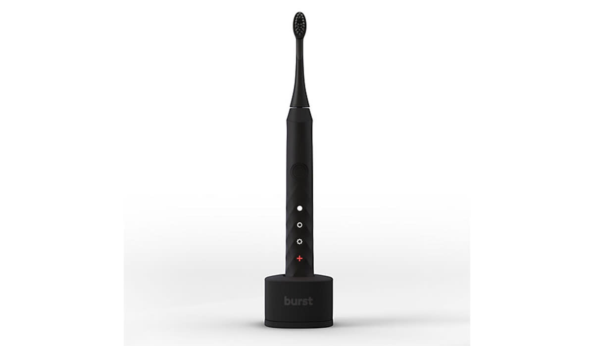 Black electric toothbrush on stand