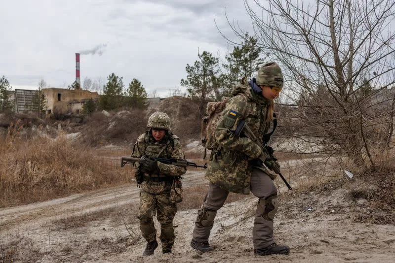 Alisa, a media relations specialist, takes part in a combat skills training conducted by the Territorial Defense Forces near Kyiv