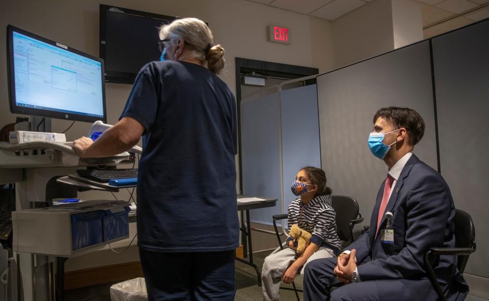 Aanya Pall. 7, of Princeton waits with Dr Harpreet Pall to receive her Covid shot. Jersey Shore University Medical Center in Neptune, NJ has begun providing Covid-19 vaccine shots for children on November 4, 2021. 