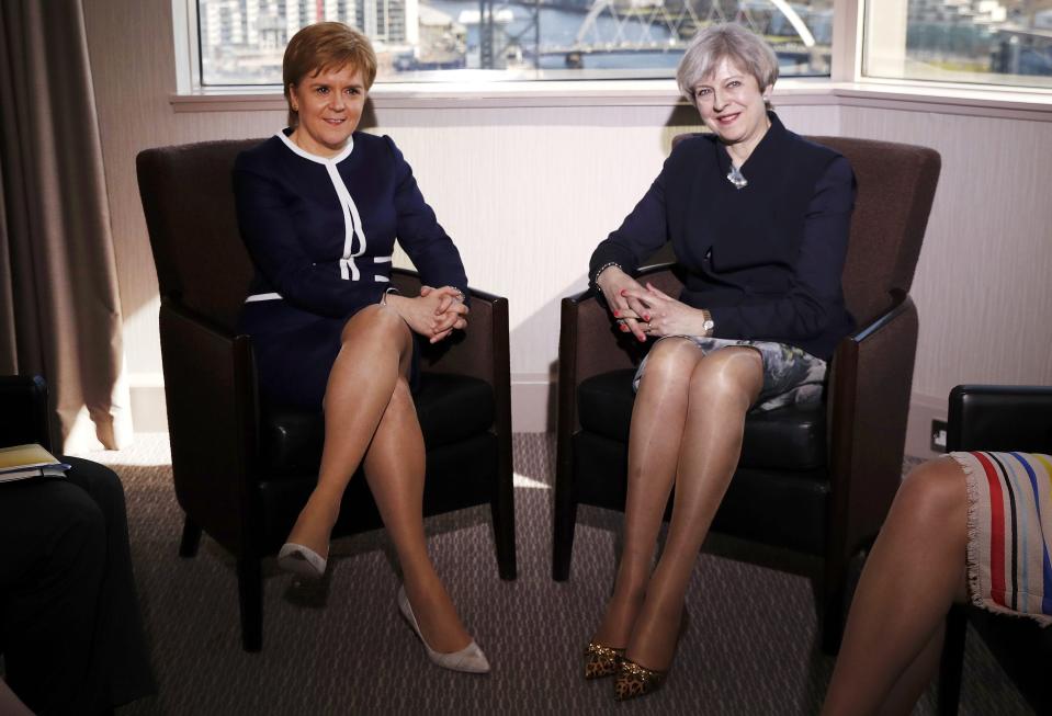 Britain's Prime Minister Theresa May, right, and Scotland's First Minister Nicola Sturgeon sit during their meeting in Glasgow, Scotland, Monday March 27, 2017. May met with Scotland's leader Monday for the first time since they faced off in a struggle over a new push for Scottish independence as the U.K. leaves the European Union. (Russell Cheyne/PA via AP)