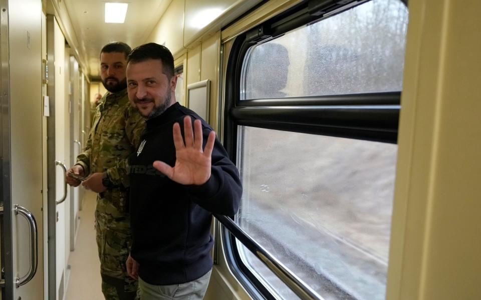 Ukrainian President Volodymyr Zelensky waves goodbye after an interview with The Associated Press on a train traveling from the Sumy region to Kyiv - Efrem Lukatsky/AP