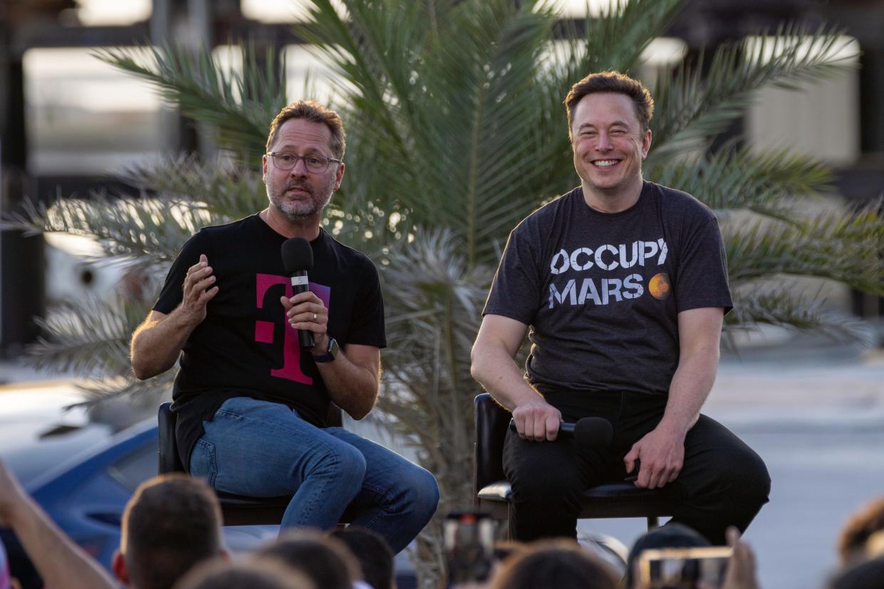 SpaceX founder Elon Musk and T-Mobile CEO Mike Sievert on stage during a T-Mobile and SpaceX joint event on August 25, 2022 in Boca Chica Beach, Texas. The two companies announced plans to work together to provide T-Mobile cellular service using Starlink satellites.