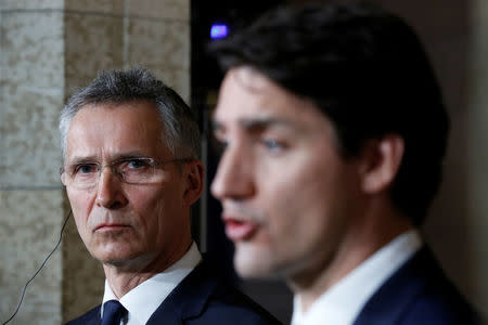 NATO Secretary General Jens Stoltenberg listens to Canada's Prime Minister Justin Trudeau speak during a news conference on Parliament Hill in Ottawa, Ontario, Canada, April 4, 2018. REUTERS/Chris Wattie