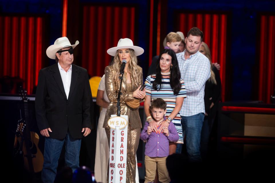 Lainey Wilson is joined on stage by her family while being inducted into the Grand Ole Opry on June 7, 2024.