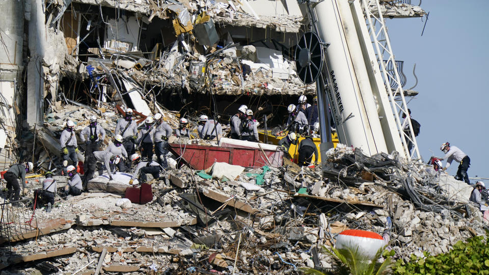 Workers search the rubble at the Champlain Towers South Condo, Monday, June 28, 2021, in Surfside, Fla. Many people were still unaccounted for after Thursday's fatal collapse. (AP Photo/Lynne Sladky)