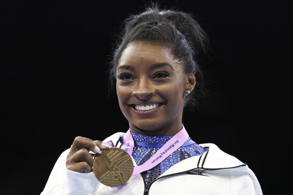 FILE - United States' Simone Biles shows her gold medal after the women's all-round final at the Artistic Gymnastics World Championships in Antwerp, Belgium, Friday, Oct. 6, 2023. Biles was named the AP Female Athlete of the Year for a third time on Friday, Dec. 22, 2023, after winning national and world all-around titles in her return to gymnastics following a two-year break after the Tokyo Olympics. (AP Photo/Geert vanden Wijngaert, File)