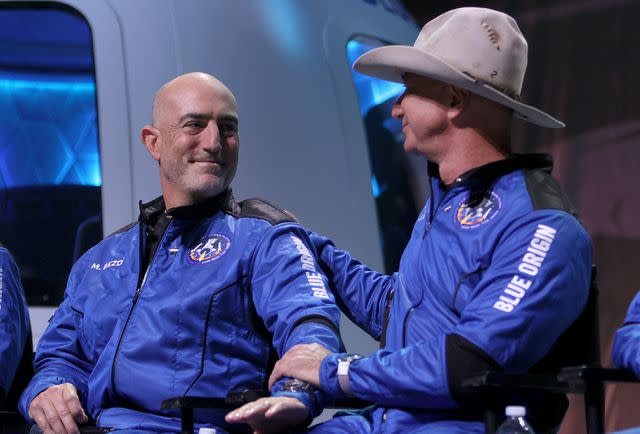 <p>Joe Raedle/Getty</p> Mark Bezos and Jeff Bezos attend a press conference after flying into space in the Blue Origin New Shepard on July 20, 2021 in Van Horn, Texas.