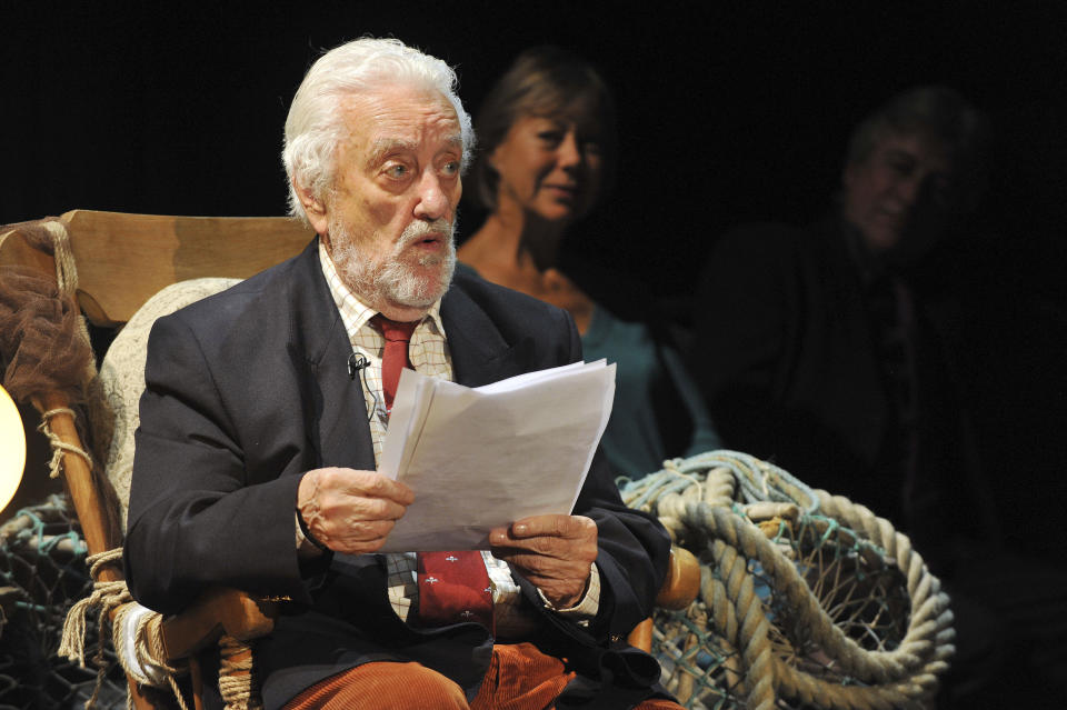 FILE Actor and presenter Bernard Cribbins, reads an excerpt from Winnie the Pooh after he received the annual J M Barrie Award for a lifetime of unforgettable work for children on stage, film, television and record, at the Radio Theatre at Broadcasting House in central London, Nov. 13, 2014. Cribbins, a beloved British entertainer whose seven-decade career ranged from the bawdy “Carry On” comedies to children’s television and “Doctor Who,” has died. He was 93. Agent Gavin Barker Associates announced Cribbins’ death on Thursday, July 28, 2022. (Nicholas.T.Ansell/PA via AP, File)