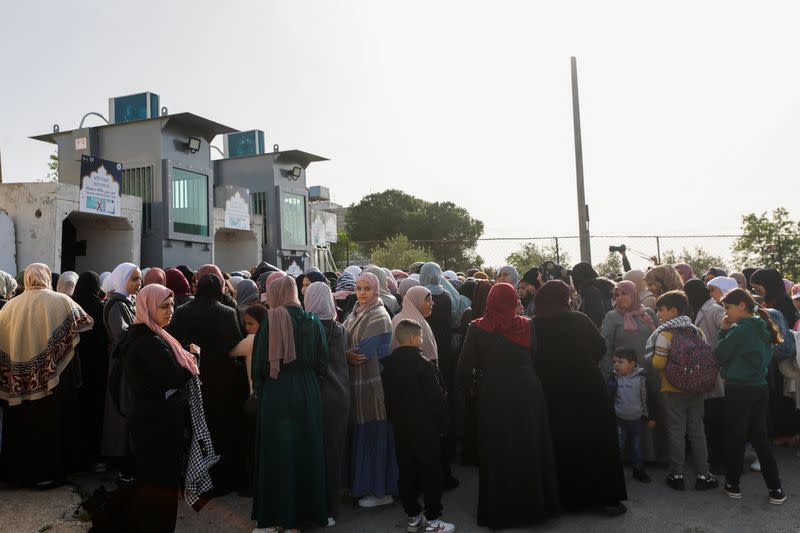 Palestinians make their way to attend the first Friday prayers of Ramadan through an Israeli checkpoint, in Bethlehem