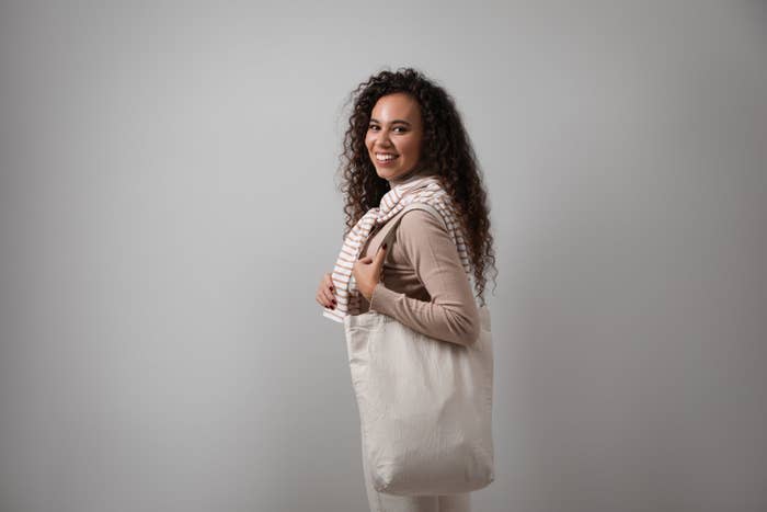 woman holds a linen shopping bag