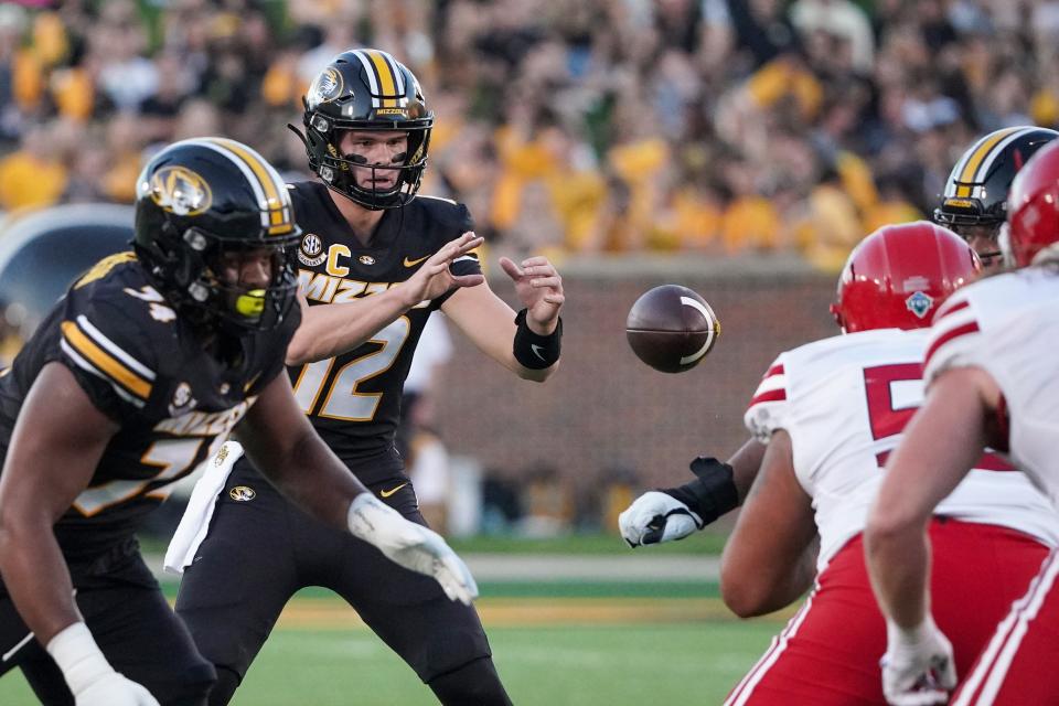 Missouri Tigers quarterback Brady Cook (12) receives a snap against the South Dakota Coyotes during the first half at Faurot Field at Memorial Stadium.