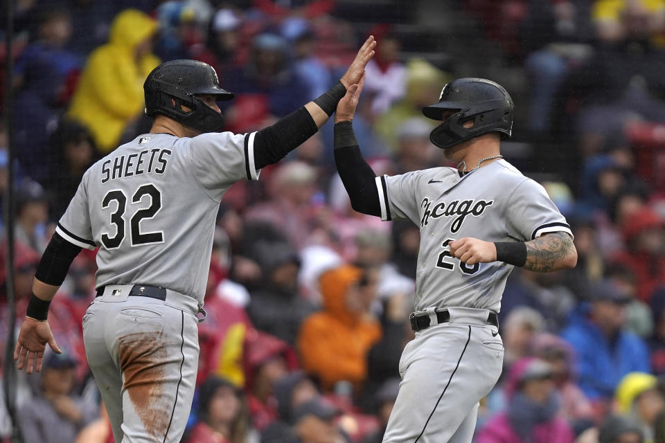 Chicago White Sox's Gavin Sheets (32) and Korey Lee celebrate after scoring on a two-run double by Elvis Andrus in the fifth inning of a baseball game against the Boston Red Sox, Sunday, Sept. 24, 2023, in Boston. (AP Photo/Steven Senne)