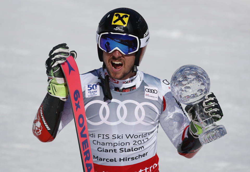 World Cup men's giant slalom overall champion Austria's Marcel Hirscher holds up the crystal globe trophy after a men's World Cup giant slalom ski race Saturday, March 18, 2017, in Aspen, Colo. (AP Photo/Brennan Linsley)