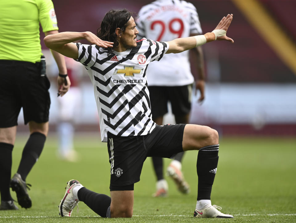 Manchester United's Edinson Cavani celebrates after scoring his side's third goal during the English Premier League soccer match between Aston Villa and Manchester United at Villa Park in Birmingham, England, Sunday, May 9, 2021. (Shaun Botterill/Pool via AP)