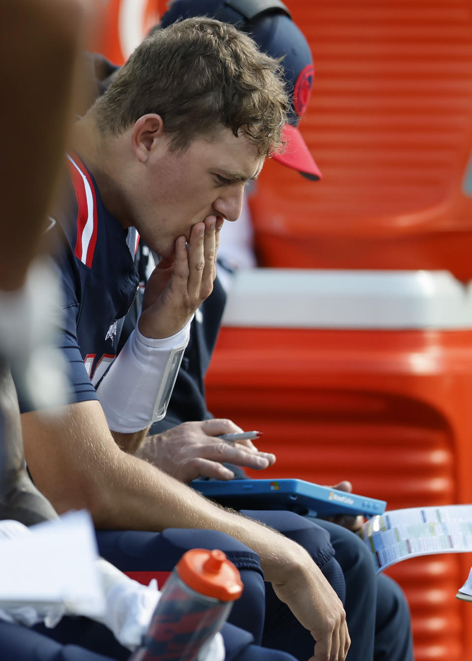 New England Patriots quarterback Mac Jones is seated on the bench during the first half of an NFL football game against the New Orleans Saints, Sunday, Oct. 8, 2023, in Foxborough, Mass. (AP Photo/Michael Dwyer)