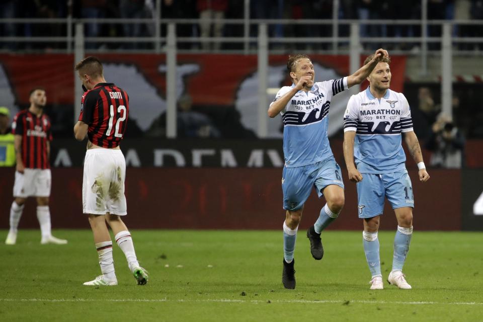 Lazio's Lucas Leiva, center, and Ciro Immobile react after the Italian Cup, second leg semifinal soccer match between AC Milan and Lazio, at the San Siro stadium, in Milan, Italy, Wednesday, April 24, 2019. Lazio won 1-0. (AP Photo/Luca Bruno)