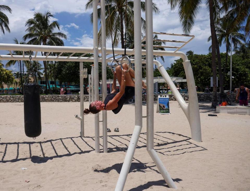 South Beach resident Juliette Lux, 23, exercises at the My Equilibra, a wellness park underneath the high noon sun as the temperature reached above 90 degrees on Miami Beach, Florida