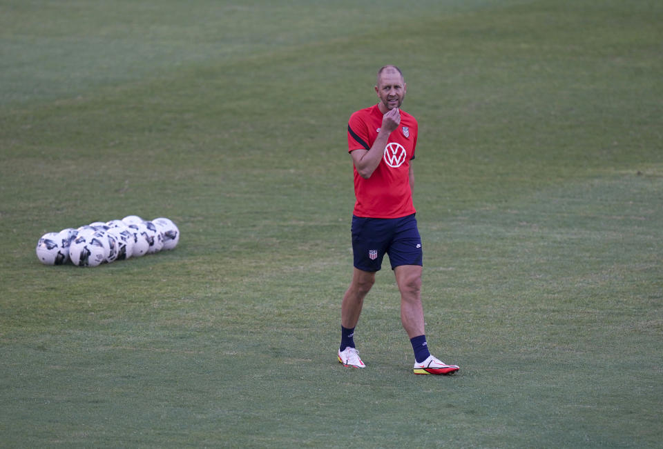 United States' head coach Gregg Berhalter walks on the pitch during a training session ahead of the World Cup 2022 qualifying soccer match against Jamaica in Kingston, Monday, Nov. 15, 2021.(AP Photo/Fernando Llano)